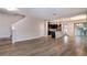 Bright and airy living space featuring wood-look tile flooring, flowing into a contemporary kitchen with a breakfast bar at 210 Wooded Vine Dr, Winter Springs, FL 32708