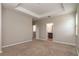 Spacious main bedroom with neutral carpet and view to en-suite bathroom and walk-in closet at 210 Wooded Vine Dr, Winter Springs, FL 32708