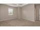 Neutral carpet, ceiling details, and ample natural light make this spacious main bedroom very inviting at 210 Wooded Vine Dr, Winter Springs, FL 32708