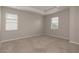 Spacious main bedroom features tray ceiling, neutral carpet, and windows for ample natural light at 210 Wooded Vine Dr, Winter Springs, FL 32708