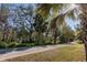 Scenic community walking path surrounded by lush greenery and palm trees, offering a peaceful outdoor experience at 210 Wooded Vine Dr, Winter Springs, FL 32708