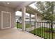 Charming patio with white pillars, black railings, and well-maintained greenery, ideal for enjoying outdoor living at 210 Wooded Vine Dr, Winter Springs, FL 32708