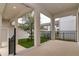 Stylish patio with white pillars, black iron railing, and green grass, perfect for outdoor relaxation and entertaining at 210 Wooded Vine Dr, Winter Springs, FL 32708