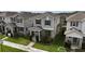 Inviting two-story home showcasing neat landscaping, gray siding, and dark blue shutters, situated in a suburban neighborhood at 210 Wooded Vine Dr, Winter Springs, FL 32708