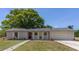 Charming single-story home features a well-maintained lawn, tasteful landscaping, and an attached two car garage at 2402 Greenwood St, Deltona, FL 32738