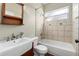 Bathroom with a tub, shower, dark vanity, and a decorative framed mirror at 2700 Child St, Ocoee, FL 34761