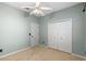 Cozy bedroom featuring carpeted floors, a ceiling fan, and a closet for ample storage at 2700 Child St, Ocoee, FL 34761