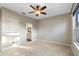 Neutral bedroom with a ceiling fan and an adjoining bathroom at 2700 Child St, Ocoee, FL 34761