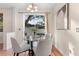 Dining area with glass table, seating for four, and sliding doors leading to the outside at 2700 Child St, Ocoee, FL 34761