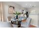 Dining area with a round glass table set for four near a modern, white kitchen at 2700 Child St, Ocoee, FL 34761