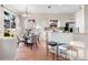 Dining area with a glass table, seating for four, and a modern, white kitchen at 2700 Child St, Ocoee, FL 34761