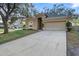 View of the home with a wide driveway and well-manicured lawn. There is plenty of room for parking at 2700 Child St, Ocoee, FL 34761