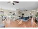 Open-concept living room showcases wood floors, neutral walls, a ceiling fan, and seamless flow to the kitchen at 2700 Child St, Ocoee, FL 34761