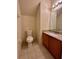 Cozy bathroom featuring a modern vanity with a granite countertop and tile flooring at 2952 Ashland S Ln, Kissimmee, FL 34741