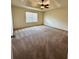 Carpeted bedroom with ceiling fan and large windows at 2952 Ashland S Ln, Kissimmee, FL 34741