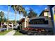 Welcoming entrance to Townhomes at Flora Ridge, featuring lush landscaping and a decorative stone wall at 2952 Ashland S Ln, Kissimmee, FL 34741