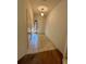 Bright hallway features neutral tile flooring leading to a white paneled front door and a carpeted area at 2952 Ashland S Ln, Kissimmee, FL 34741