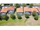 Aerial view of homes with screened-in pools and tile roofs at 304 Summer Place Loop, Clermont, FL 34714