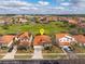 Aerial view of a neighborhood highlighting a house with orange tile roof and a yellow pin marker at 304 Summer Place Loop, Clermont, FL 34714