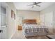 This bedroom features a bed, a ceiling fan, neutral colored walls, and carpet flooring at 304 Summer Place Loop, Clermont, FL 34714