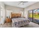 Bright bedroom features a ceiling fan, neutral walls, and a sliding door leading to the outdoor patio at 304 Summer Place Loop, Clermont, FL 34714