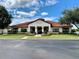 Charming High Grove Clubhouse featuring manicured landscaping and a welcoming facade with covered entryway at 304 Summer Place Loop, Clermont, FL 34714