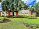 Beautifully landscaped entrance to High Grove community, featuring lush greenery and elegant signage at 304 Summer Place Loop, Clermont, FL 34714