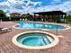 Inviting community pool with hot tub, gazebo, and lounge chairs, perfect for relaxation and recreation at 304 Summer Place Loop, Clermont, FL 34714