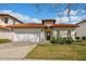 Charming home featuring a well-manicured lawn, tile roof, and a two-car garage with a traditional front door at 304 Summer Place Loop, Clermont, FL 34714