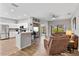 Bright and open living room featuring wood look tile flooring and comfortable seating, connects to kitchen at 304 Summer Place Loop, Clermont, FL 34714