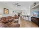 Spacious open-concept living room featuring wood-look tile flooring and comfortable seating open to the kitchen at 304 Summer Place Loop, Clermont, FL 34714