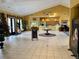 Spacious lobby area with large windows and neutral colors, featuring a reception desk and seating at 304 Summer Place Loop, Clermont, FL 34714