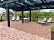 Outdoor patio area with a pergola, seating, and lounge chairs at 304 Summer Place Loop, Clermont, FL 34714