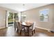 Bright dining room featuring a wooden table set, chandelier, and sliding glass doors to the backyard at 3136 Winesap Way, Winter Garden, FL 34787