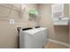 Bright laundry room equipped with a washer, dryer, and overhead storage at 3136 Winesap Way, Winter Garden, FL 34787