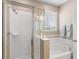 Primary bathroom featuring a glass shower, soaking tub, and white tile at 3136 Winesap Way, Winter Garden, FL 34787