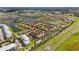 An aerial view shows a beautiful community with many amenities near a lake and a highway at 3197 Pequod Pl, Kissimmee, FL 34746