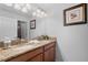 Bathroom featuring a double sink vanity with granite countertops and decorative lighting at 3197 Pequod Pl, Kissimmee, FL 34746