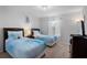 Bright bedroom with two beds and a dark wood dresser at 3197 Pequod Pl, Kissimmee, FL 34746