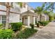 Inviting entryway with a covered porch and lush landscaping at 3197 Pequod Pl, Kissimmee, FL 34746