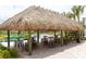 An outdoor bar offers tables, seating, and sun protection with a straw roof at 3197 Pequod Pl, Kissimmee, FL 34746