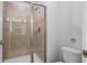 Shower stall with a glass door and tiled walls, next to a toilet at 3197 Pequod Pl, Kissimmee, FL 34746