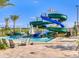 Water slides and swimming pool with seating area, perfect for cooling off during summer at 3197 Pequod Pl, Kissimmee, FL 34746