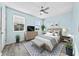 Comfortable bedroom featuring ample natural light, a ceiling fan, and wood floors at 3406 Soho St # 201, Orlando, FL 32835