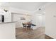 Dining area featuring bench seating, a wicker pendant light, and views of the kitchen at 3406 Soho St # 201, Orlando, FL 32835