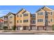 Exterior shot of townhome featuring attached garages, multiple windows, and neutral color scheme at 3406 Soho St # 201, Orlando, FL 32835