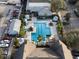 Aerial view of an inviting community pool area with gazebos, lounge chairs, and well-maintained landscaping at 3406 Soho St # 201, Orlando, FL 32835