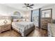 Cozy bedroom with modern ceiling fan, natural light, and hardwood floors at 3430 Halsway Dr, Orlando, FL 32824