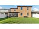 Back exterior view of a two-story home with a screened-in lanai and a spacious backyard at 3430 Halsway Dr, Orlando, FL 32824