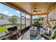 Relaxing screened lanai featuring a ceiling fan, outdoor seating, a gas grill and a view of the backyard at 3430 Halsway Dr, Orlando, FL 32824